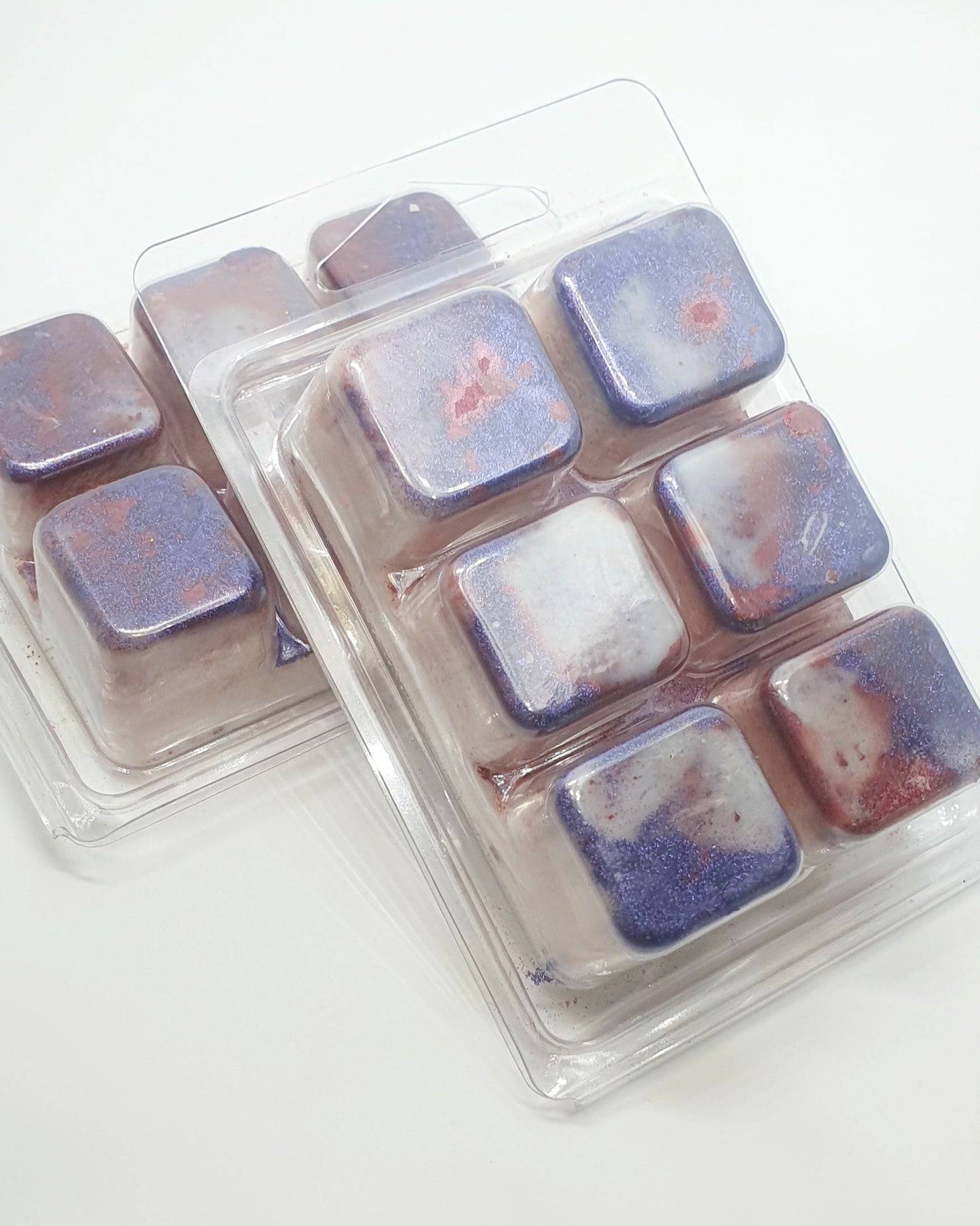 Pack of wax melts with a marbled design in purple and white on a white background