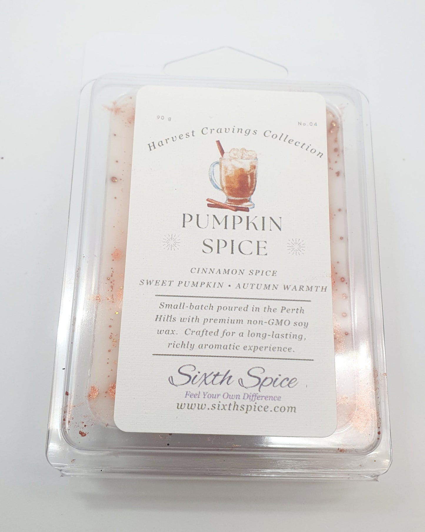 Pumpkin spice wax melt in a clear container with a label on a white background