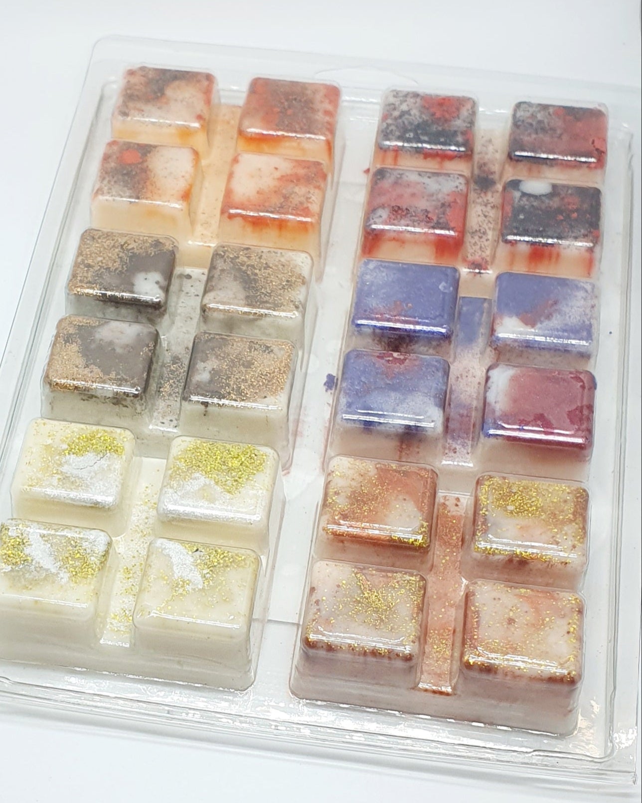 A trays of square wax melts with various colors on a white background