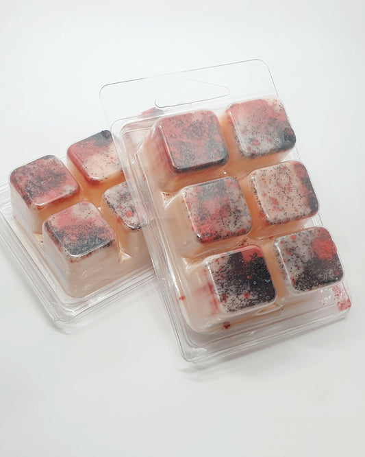 Packaged wax melts with a red and black color on a white background