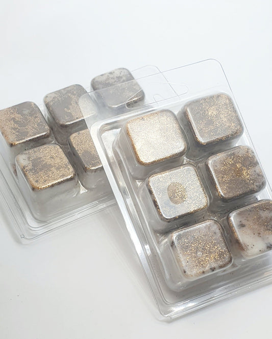 Packaged square wax melts with metallic finish on a white background