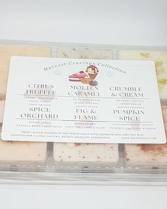 Assorted small batch sweet scented wax melts in a clear container with a label on a white background